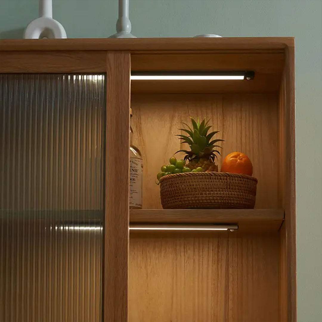 Ultra-slim motion sensor closet light with metal exterior, wire-free and USB rechargeable, illuminating wooden cabinet shelves