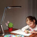 Serene Eye-Friendly desk lamp in mocca gold illuminating a child's study area with adjustable light and modern design
