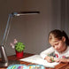 Serene Eye-Friendly desk lamp in mocca gold illuminating a child's study area with adjustable light and modern design