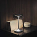 Modern crystal cordless table lamp with smoky glass shade on a sleek aluminum base