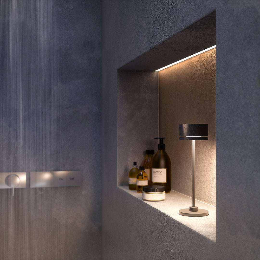 Duplo cordless table lamp in a modern bathroom setting with sleek design and ambient lighting.