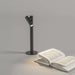 Zoom Desk cordless rechargeable LED lamp with flexible dimming and removable head illuminating open book on desk