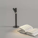 Zoom Desk cordless rechargeable LED lamp with flexible dimming and removable head illuminating open book on desk