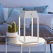 Handy solar rechargeable lantern on white table beside potted cactus in modern living room setting