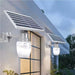 Elant Solar Golden Apple Light mounted on wall with solar panel illuminating outdoor space at dusk