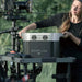 EcoFlow DELTA MAX portable power station in outdoor filming setup with woman operating it