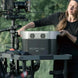 EcoFlow DELTA MAX portable power station in outdoor filming setup with woman operating it