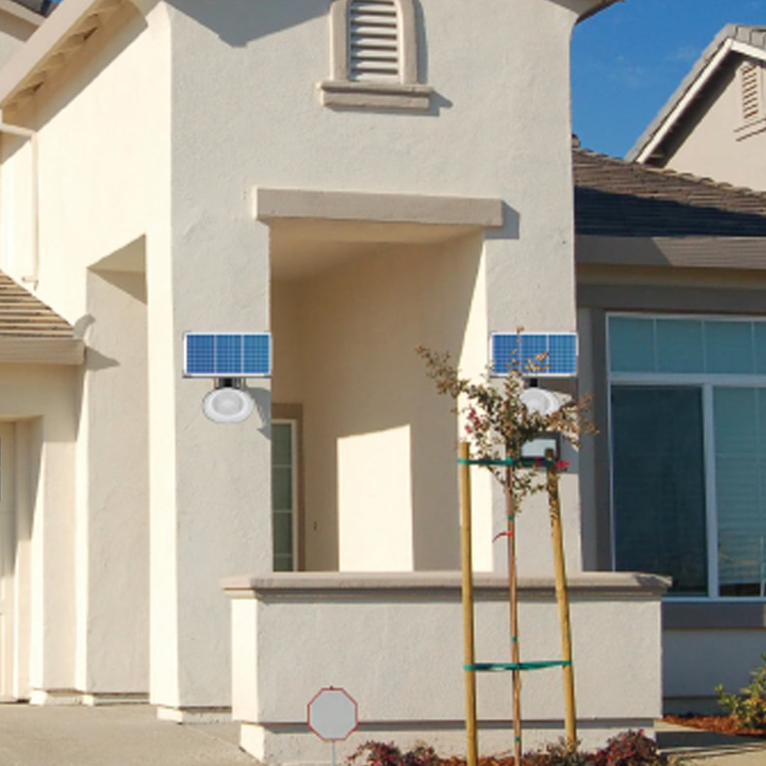 Wall-mounted solar garden light with 5V/50W solar panel and LED lamp on house exterior