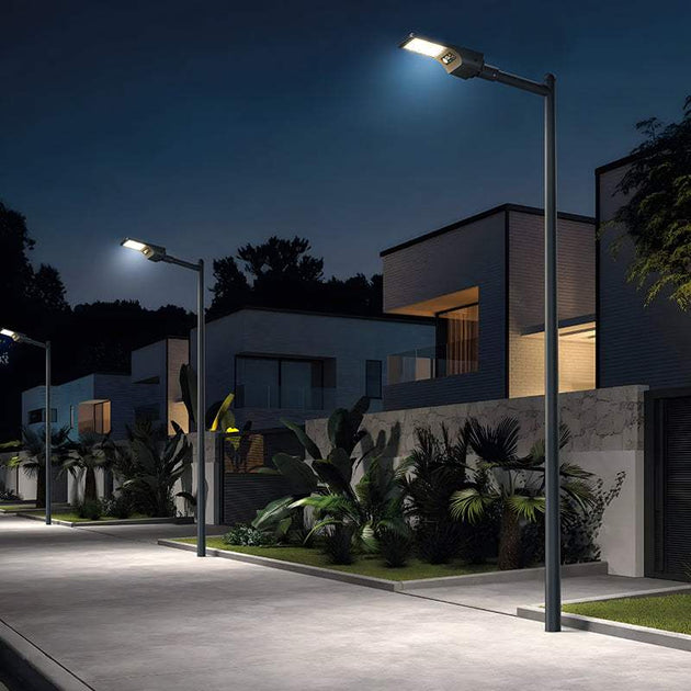 Street with modern integrated solar lights illuminating residential area at night