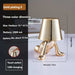 Little Golden Man Table Lamp with three-color dimming and USB charging.