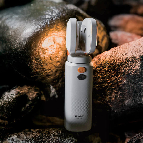 Compact Elant ECP002 multifunctional camping light with adjustable dual heads and magnetic base on rocky outdoor surface