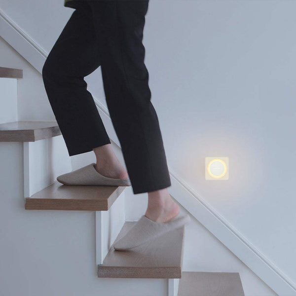 Yeelight Plug-In-Light sensor nightlight glowing softly on wall near stairs in dim lighting