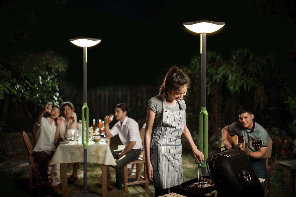 LUTEC Poppy solar LED floor lamp with speaker illuminating outdoor garden at night