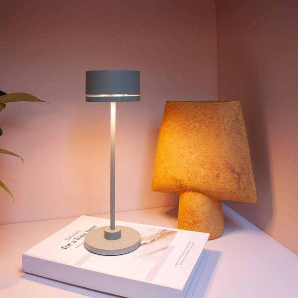 Sleek Duplo cordless table lamp on a desk, showcasing modern design and portability.