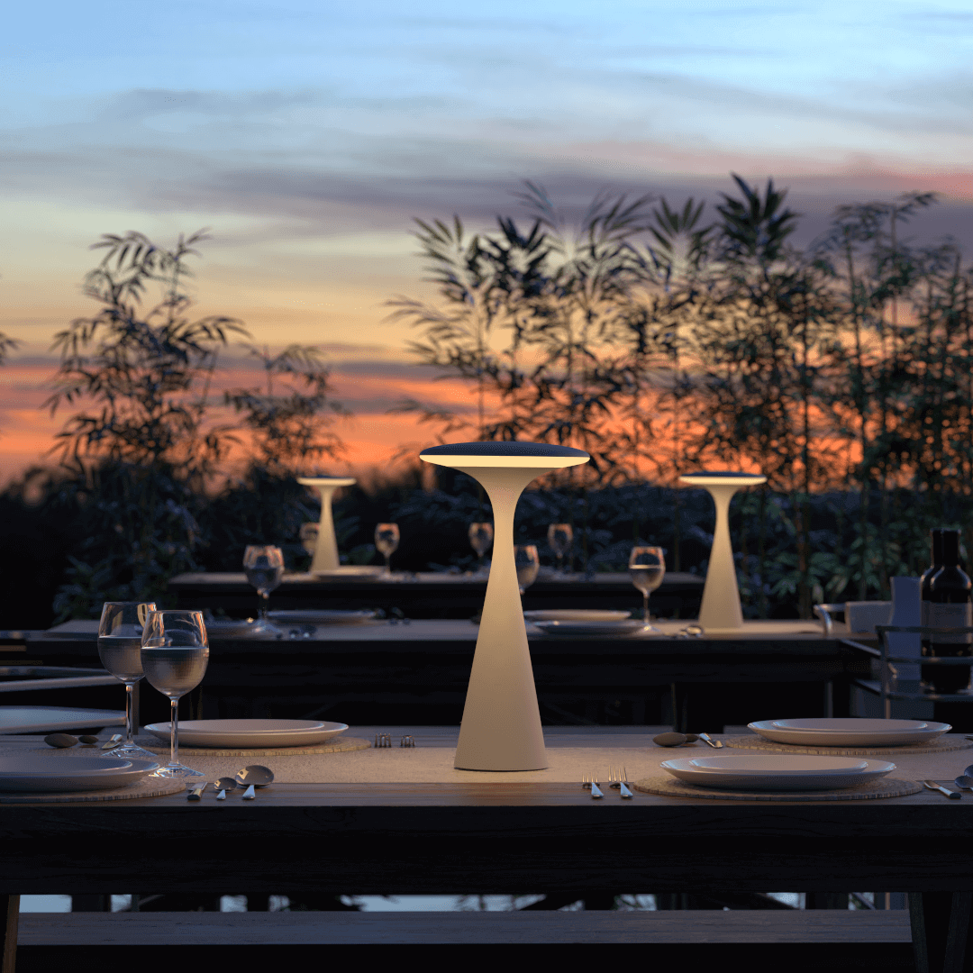 Elant Dusk rechargeable table lamp on outdoor dining table at sunset