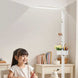 Sakura F004 eye-care floor lamp with full-spectrum lighting over a young girl studying in a bright room