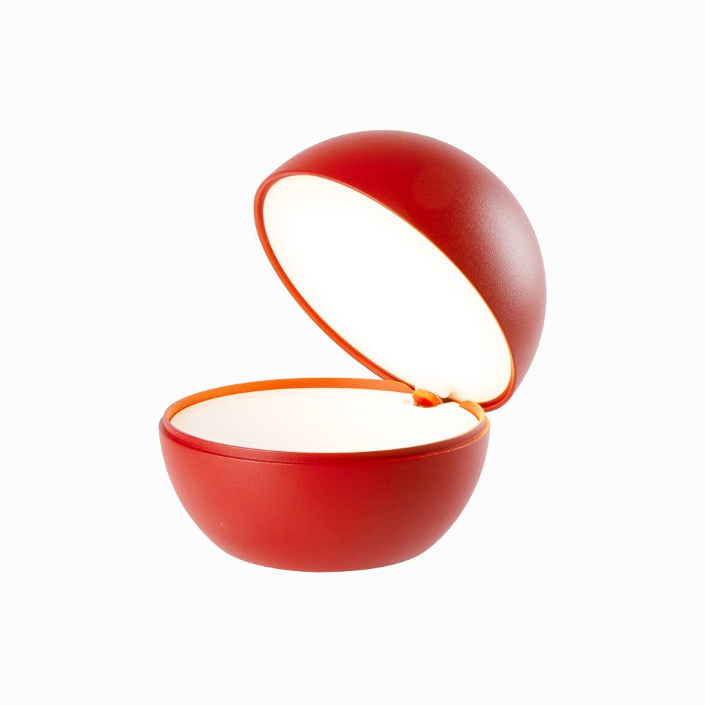 Cordless table lamp with a round ball-like design in red, featuring LED rechargeable lighting and mechanical switch.
