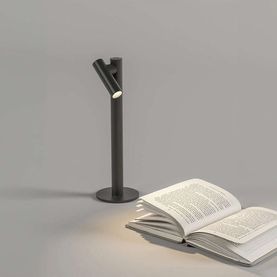 Zoom Desk cordless rechargeable LED lamp with flexible dimming and removable head illuminating open book on desk