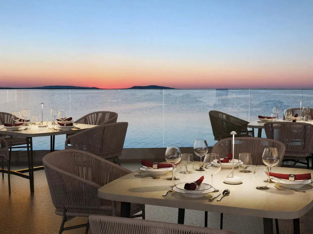 LUME Rechargeable Table Lamp on outdoor dining table at sunset.