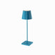 Plissé cordless table lamp with blue pleated shade and sleek design.