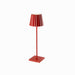 Red Plissé cordless table lamp, featuring a sleek aluminum design with frosted poly-carbonate diffuser, LED technology, and touch switch functionality.