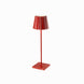 Red Plissé cordless table lamp, featuring a sleek aluminum design with frosted poly-carbonate diffuser, LED technology, and touch switch functionality.