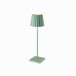 Green Plissé cordless table lamp with pleated shade standing on a square base.