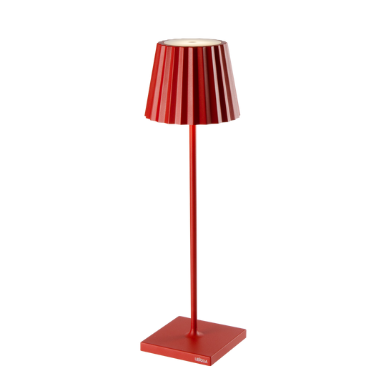 Red Plissé cordless table lamp with a contemporary design, featuring a fluted shade and a sleek stand.