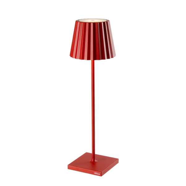 Red Plissé cordless table lamp with a contemporary design, featuring a fluted shade and a sleek stand.