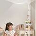 Sakura F004 eye-care floor lamp with full-spectrum lighting over a young girl studying in a bright room