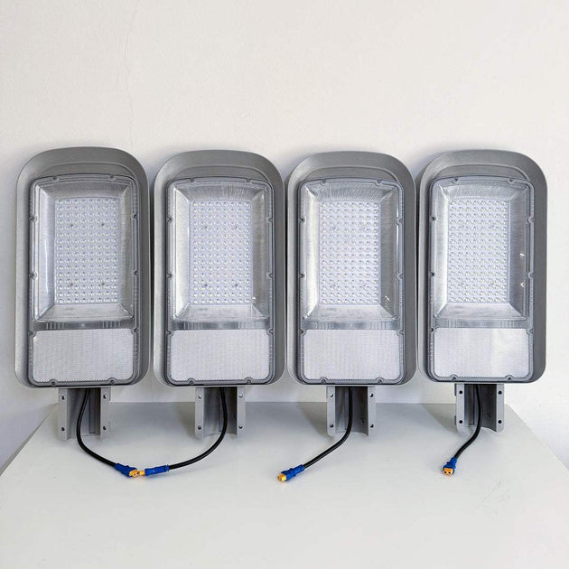 Set of four Solar Grain Street Lights with integrated LED panels and mounting brackets, designed for eco-friendly outdoor illumination.