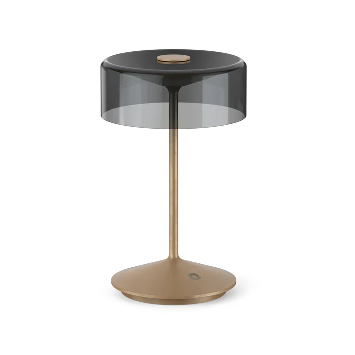 Cordless table lamp with smoky glass shade and gold base.