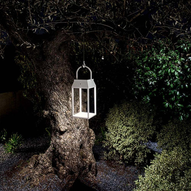 Solar Handy Lantern illuminating a garden pathway, eco-friendly outdoor lighting solution.