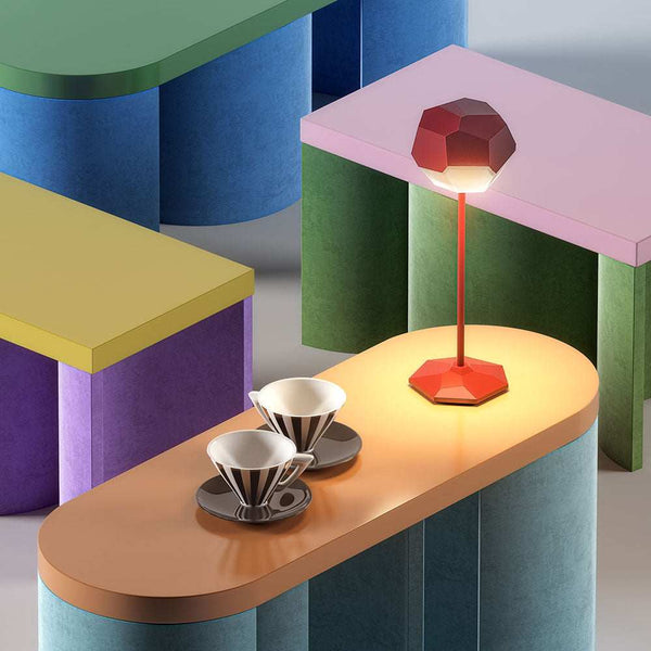 Modern LED rechargeable table lamp with geometric design on colorful tables